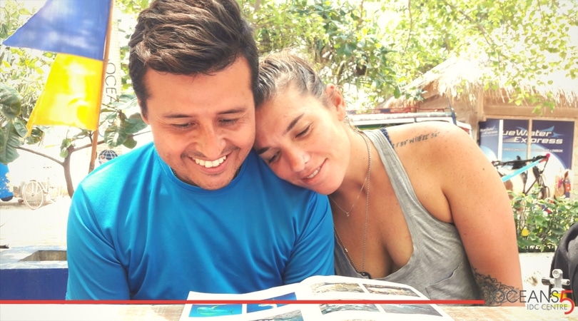 Megan and Sal looking at a fish ID book after a dive